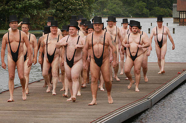 men-dressed-as-greedy-businessmen-wearing-mankini-swimming-costumes-picture-id102130973